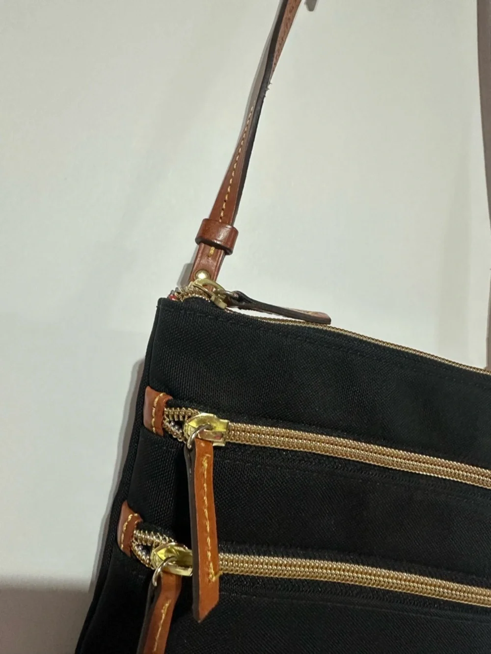 Dooney & Bourke North South Triple Zip Black Crossbody with Brown Leather Strap